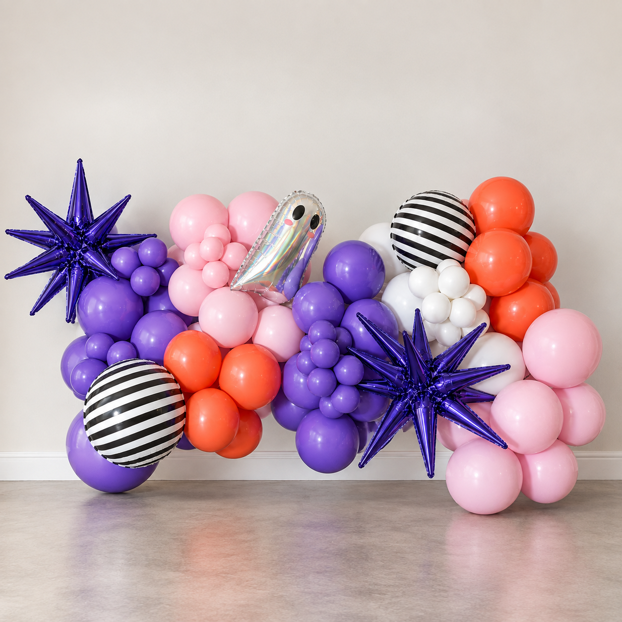 Pink, purple, orange and white Halloween balloon garland with ghost and starburst accents